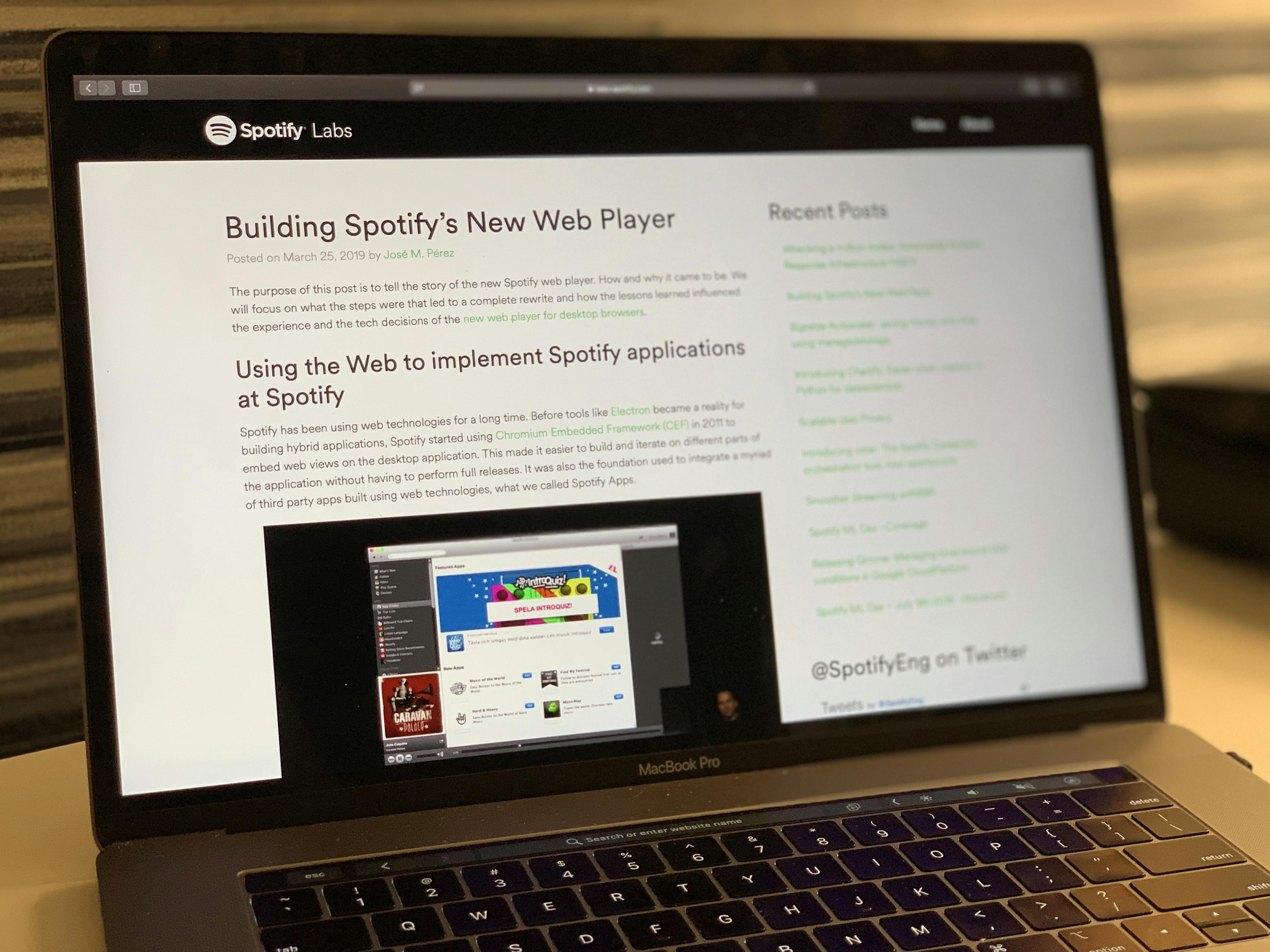 A picture of a laptop showing Spotify's Web Player